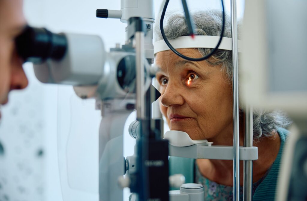 A person having their eyes examined with a slit lamp by an eye doctor after experiencing vision issues.