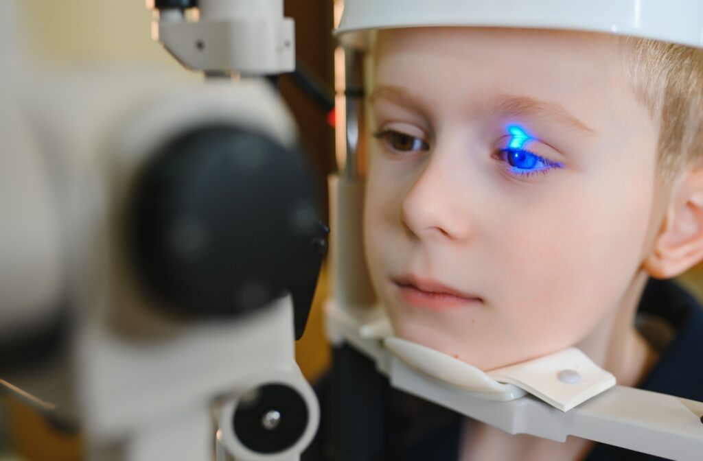 A young boy having an eye exam to monitor for signs of eye disease.